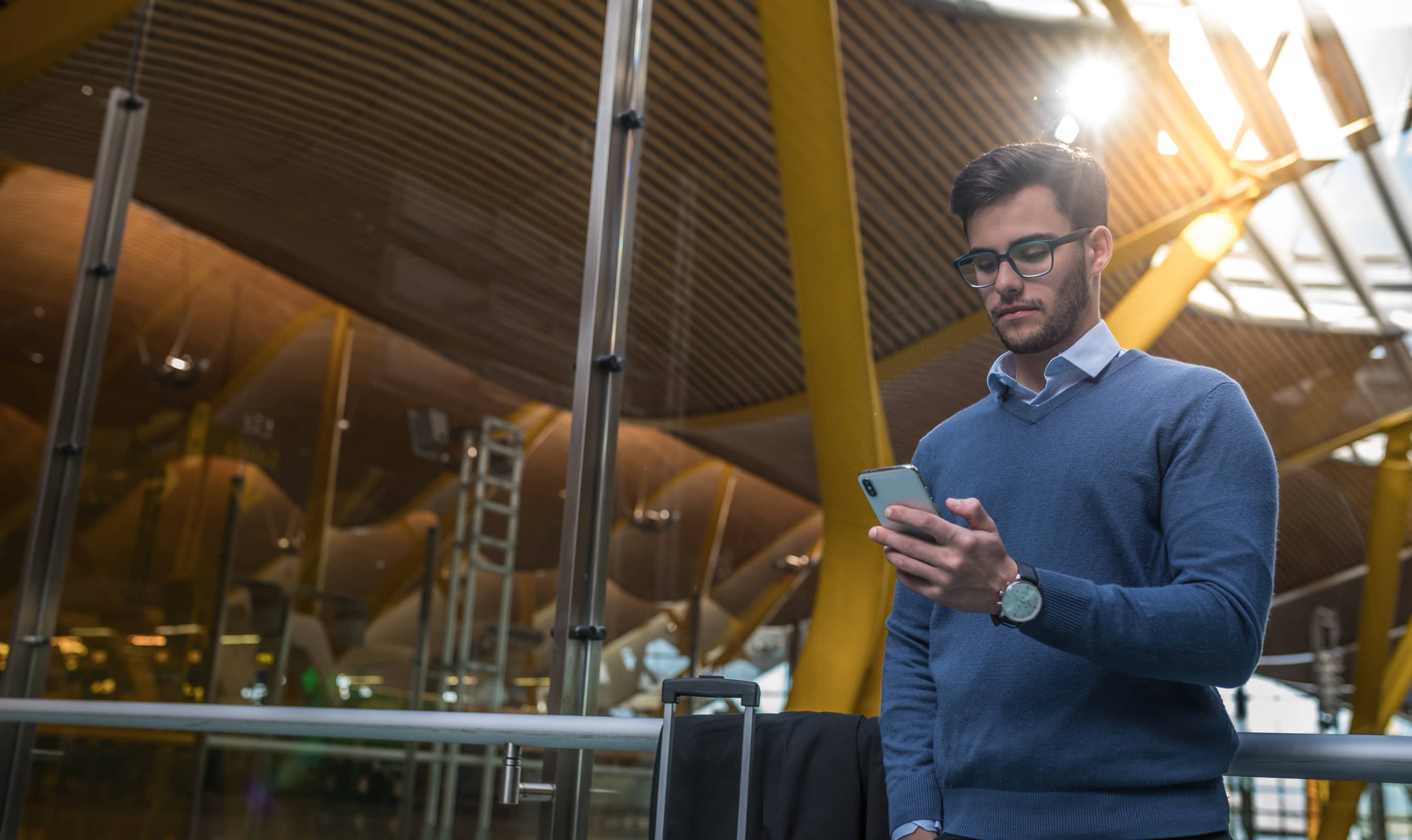 Person with phone on travelator